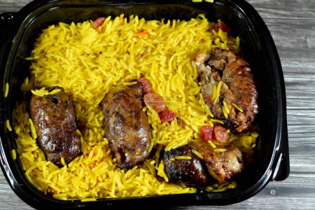 Photo for Arabic cuisine traditional food beef  Kofta, kebab and tarb kofta shish which is minced meat with Basmati rice and raisins, oriental grilled barbecued meat food with long yellow rice, selective focus - Royalty Free Image