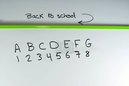 Photo for Back to school texture on a school white board for teaching children the alphabet ABCD and numbers 1234, teaching, learning, school, kindergarten, preschool, primary school concept, selective focus - Royalty Free Image