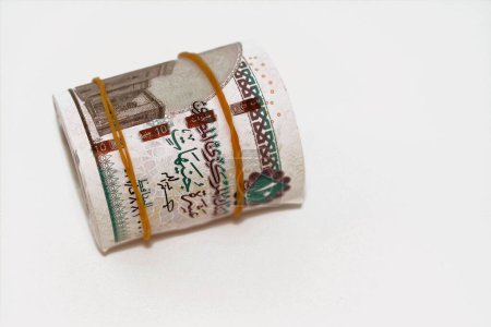 Photo for 10 EGP LE ten Egyptian pounds cash money bills rolled up with rubber bands with a image of Al Rifa'i the royal mosque and khafre enthroned, Egypt money bundle roll, selective focus - Royalty Free Image
