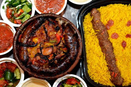 Photo for Traditional Egypt beef  Kofta, kebab and tarb kofta shish with mixture of lamb meat, sausage mumbar intestines filled with rice, kawareh trotters cow feet, pieces of cooked kidneys, heart, testicles - Royalty Free Image