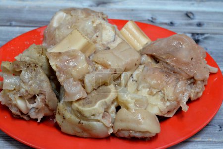 Photo for Arabic Egyptian cuisine of kawareh trotters and knee boiled with soup full of collagen and Gelatin, cooked cow feet and knees, trotters bone stew, good for muscle and immunity, selective focus - Royalty Free Image