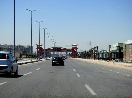 Photo for Cairo, Egypt, April 16 2023: Shinzo Abe axis patrol highway in Egypt with a pedestrian bridge finished in traditional Japanese architectural style, the traffic highway is named on former Japanese PM - Royalty Free Image