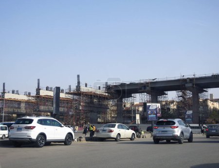 Foto de El Cairo, Egipto, 18 de abril de 2023: sitio de monorraíl de El Cairo que está en construcción por la compañía Orascom con las columnas y las vías en la ciudad de Nuevo Cairo, sistema de tránsito rápido, conductor más largo menos monorraíl - Imagen libre de derechos