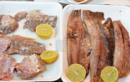 Traditional meal of Fesikh which is fermented, salted and dried gray mullet fish of the genus Mugil and Pieces of hot smoked herring fish fillets and soft roe prepared with oil and lemon
