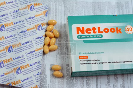 Photo for Cairo, Egypt, May 2 2023: NetLook soft gelatin capsules, Isotretinoin is an oral prescription medication that affects sebaceous glands and is used to treat severe acne vulgaris skin disease - Royalty Free Image