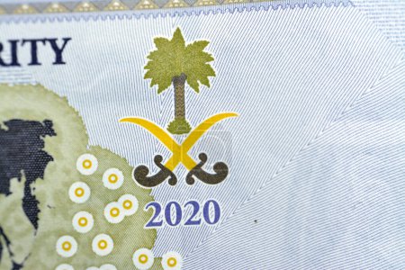 Photo for Saudi Arabian emblem from everse side of 20 SAR twenty Saudi Arabia Riyals banknote currency bill money Commemorative issue with a map of the world depicting G20 summit countries in a different color - Royalty Free Image