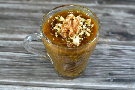 Photo for Egyptian Moghat drink with walnuts and nuts  popular after pregnancy and labor, Glossostemon bruguieri, The dried peeled roots, used in traditional medicine for many nutritional and medicinal values - Royalty Free Image