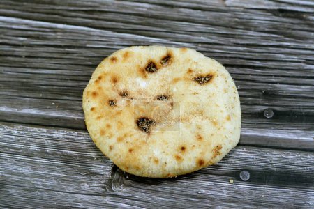 Photo for Mini traditional Egyptian flat bread with wheat bran and flour, small Aish Baladi or small bread baked in extremely hot ovens, it is the result of a mixture of wheat flour, yeast, salt and water - Royalty Free Image