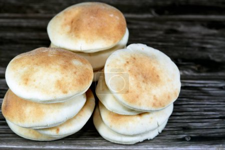 Photo for Mini traditional Shami flat bread with wheat and flour, small Aish Shamy or small pita bread baked in extremely hot ovens, it is the result of a mixture of wheat flour, yeast, salt and water - Royalty Free Image