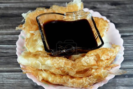 Photo for Egyptian Feteer meshaltet, layers upon layers of pastry dough with loads of ghee or butter in between with Molasses, a viscous substance resulting from refining sugarcane or sugar beets into sugar - Royalty Free Image