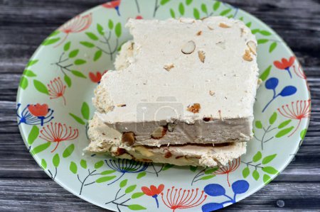 Photo for Traditional tahini halva with almonds or Halawa Tahiniya, the primary ingredients in this confection are sesame butter or paste (tahini), and sugar, glucose or honey, it is basic tahini and sugar base - Royalty Free Image