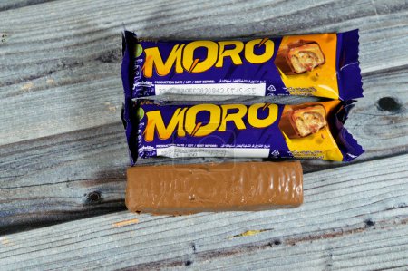 Photo for Cairo, Egypt, June 10 2023: Cadbury Moro Chocolate caramel bar, a delicious fusion of crunchy peanuts, sweet caramel, and a creamy center all coated in smooth milk chocolate, selective focus - Royalty Free Image