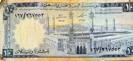 Photo for Large fragment of the obverse side of 10 SAR Saudi Arabia riyals cash money currency banknote features Al-Masjid al-Haram (Holy mosque), Mecca, vintage retro old 10 riyals, selective focus - Royalty Free Image