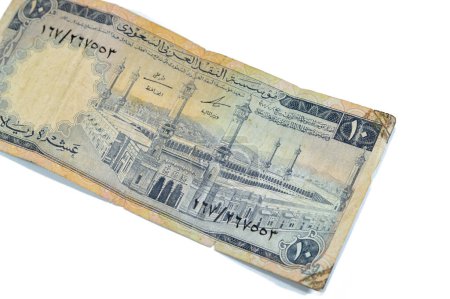 Photo for Obverse side of 10 SAR Saudi Arabia riyals cash money currency banknote features Al-Masjid al-Haram (Holy mosque), Mecca, vintage retro old 10 riyals, selective focus - Royalty Free Image