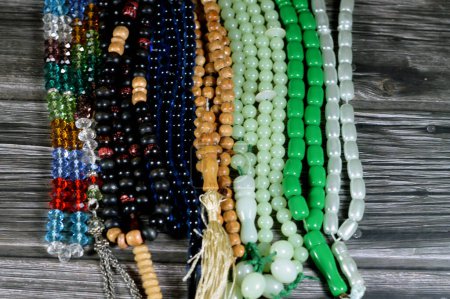 Photo for Prayer beads, a form of beadwork used to count the repetitions of prayers, A misbaha, a device used for counting tasbih zekr Islamic prayers praising Allah, has 2 forms 99 beads and 33 beads - Royalty Free Image