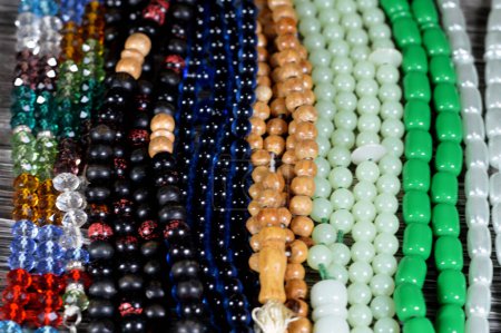 Photo for Prayer beads, a form of beadwork used to count the repetitions of prayers, A misbaha, a device used for counting tasbih zekr Islamic prayers praising Allah, has 2 forms 99 beads and 33 beads - Royalty Free Image