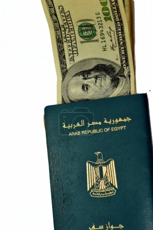 Photo for Egyptian passport with American dollars of 100 one hundred United states dollars money banknotes, Arab republic of Egypt's passport with the republican golden eagle and old American money banknotes - Royalty Free Image