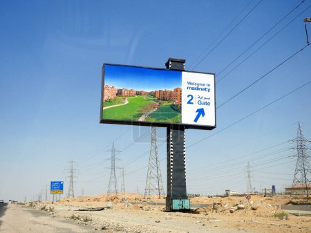 Photo for Cairo, Egypt, June 30 2023: Signboard for direction of Madinaty My City , an 8000 acre real estate development project, in the New Cairo satellite city by Talaat Mostafa Group Holding company - Royalty Free Image