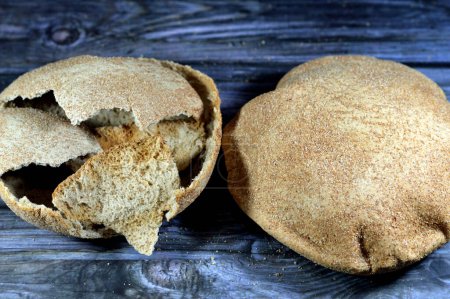 Photo for Egyptian brown bran thin crispbread bread, puff thin, crispy and delicious, eaten alone or with anything, brown circular, crunch and round baked bran whole grain breads, selective focus - Royalty Free Image