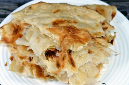 Photo for Egyptian Feteer meshaltet, layers upon layers of pastry dough with loads of ghee or butter in between, one of the famous Egyptian pastry recipes, a flaky Egyptian layered pastry bread dough and butter - Royalty Free Image