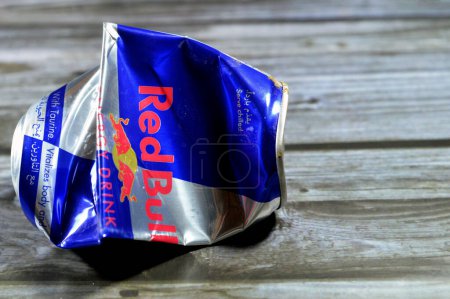Photo for Cairo, Egypt, July 28 2023: Crushed dented Red Bull energy drink, a brand of energy drinks created and owned by the Austrian company Red Bull GmbH, Its slogan, (Red Bull Gives You Wings), isolated - Royalty Free Image