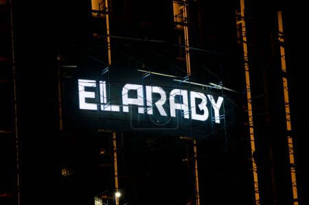 Photo for Cairo, Egypt, August 19 2023: The exterior of ElAraby building that is under construction with scaffoldings and the group company logo with lights at night, home appliances and electric products - Royalty Free Image