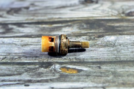 Photo for A used shower faucet tap body cartridge parts of plastic and copper that needs to be fixed or replaced for water leakage, plumbing and maintenance concept background at home, selective focus - Royalty Free Image