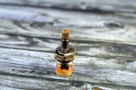Photo for A used shower faucet tap body cartridge parts of plastic and copper that needs to be fixed or replaced for water leakage, plumbing and maintenance concept background at home, selective focus - Royalty Free Image