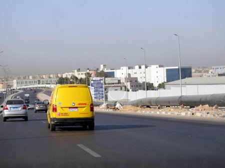 Photo for Cairo, Egypt, August 31 2023: DHL truck on its way delivering a package, DHL is the global leader in the logistics industry specializing in international shipping, courier services and transportation - Royalty Free Image