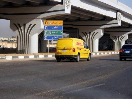 Photo for Cairo, Egypt, August 31 2023: DHL truck on its way delivering a package, DHL is the global leader in the logistics industry specializing in international shipping, courier services and transportation - Royalty Free Image