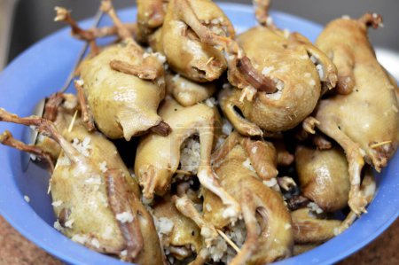 Photo for Boiled white rice stuffed pigeons or Hamam mahshi, boiled until cooked and prepared to be roasted, fried in hot oil or grilled, stuffed pigeons is a very popular Egyptian cuisine in Egypt - Royalty Free Image