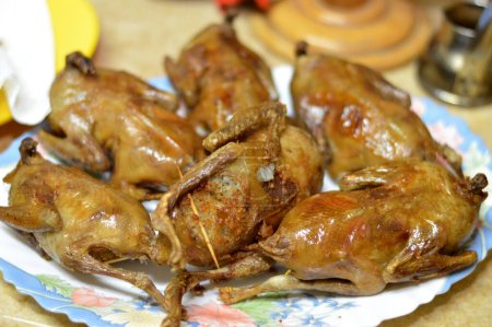 Photo for Roasted and fried pigeons stuffed with white rice or Hamam mahshi, boiled until cooked then roasted, fried in hot oil or grilled, stuffed pigeons is a very popular Egyptian cuisine in Egypt - Royalty Free Image