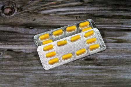Photo for Medication capsules, yellow capsules, treatment, remedy, drug usage, abuse, prescription concept, painkillers and antibiotics, analgesics, taking a medication tablets, pill background - Royalty Free Image