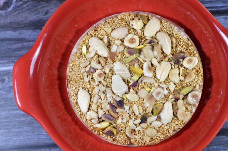 Photo for Confectionery sweet circular Eastern candy made of sugar, sesame, nuts, hazelnuts, almonds and pistachios, a special dessert disc as a celebration of Maloud Mawled Nabawy or the prophet's birth - Royalty Free Image