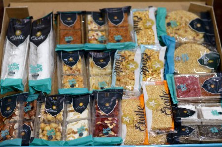 Photo for Cairo, Egypt, September 29 2023: Box of Etolie collection of various Eastern candies, peanuts, sesame, chocolate, nuts, hazelnuts and, almonds as a celebration of the prophet's Mohamed birthday - Royalty Free Image