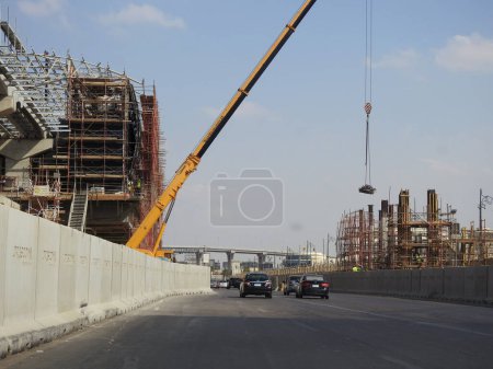 Photo for Cairo, Egypt, October 5 2023: Cairo monorail station site that is under construction by Orascom with the columns, the tracks, crane, scaffolds, rapid transit system, longest driver less monorail - Royalty Free Image