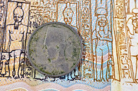 Photo for Round metal two 2 Egyptian milliemes series 1938 AD 1357 AH features bust of King Farouk I of Egypt on obverse side and value and date on reverse side, ancient old historic coin of kingdom of Egypt - Royalty Free Image