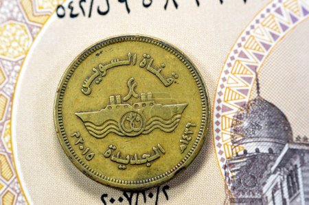 Photo for Translation of the Arabic text (New Suez Canal), with the slogan of ships crossing the Suez Canal in Egypt, Memorial for New Suez canal of Egypt on Egyptian 50 piasters half Pound coin on 1 LE note - Royalty Free Image