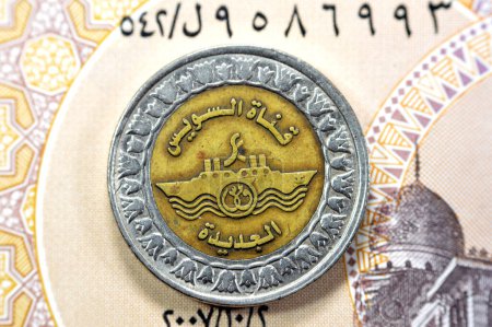 Photo for Translation of the Arabic text (New Suez Canal), with the slogan of ships crossing the Suez Canal in Egypt, Memorial for New Suez canal of Egypt on the Egyptian one pound 1 LE EGP coin on 1 LE note - Royalty Free Image