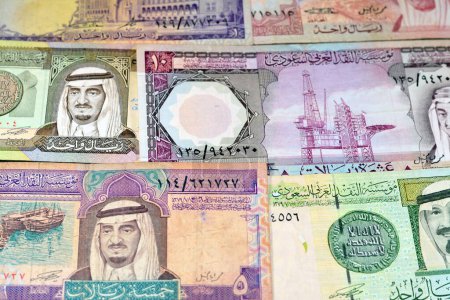 Photo for Old Saudi Arabia riyals money banknote bills of different eras from the kingdom of Saudi Arabia times, vintage retro old Saudi currency, value, exchange rate of the currency, old notes - Royalty Free Image