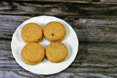 Photo for Chocolate coated oat biscuits, sweet treat during the day as a snack, Oatmeal Biscuits are soft sweet biscuits made from flour, oatmeal, butter, honey, and milk coated with chocolate, selective focus - Royalty Free Image