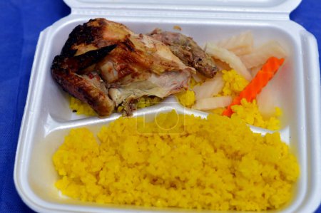 Photo for Yellow rice cooked on hot steam, grilled chicken breast with bones and Eastern pickles, marinated carrot slices, turnip pieces, yellow rice with a quarter of chicken cooked on a grill, selective focus - Royalty Free Image