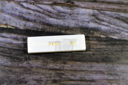 Photo for Negative result of rapid urine pregnancy test, detecting human chorionic gonadotropin HCG in female urine if pregnant in pregnancy test kit, a modern hormone pregnancy test, selective focus - Royalty Free Image