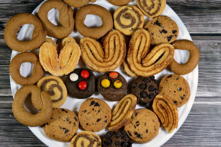 Assorted baked cookies and biscuits of cinnamon biscuits, baked round biscuits that are hard, flat and crispy, chocolate butter cookies and palmier, short for feuille de palmier, French cookies