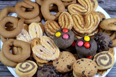 Assorted baked cookies and biscuits of cinnamon biscuits, baked round biscuits that are hard, flat and crispy, chocolate butter cookies and palmier, short for feuille de palmier, French cookies
