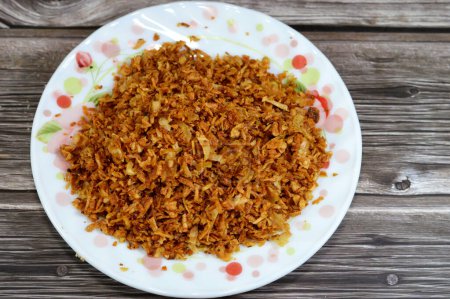 Fried onions, that is used for topping of Koshary Egyptian cuisine, lentils, rice, chickpeas, with a special tomato sauce and savory crispy onions on top, sliced onions, salt, cornstarch then fried