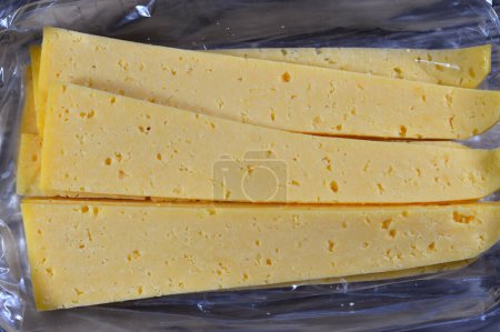 Slices of Egyptian Rumi cheese, also called gebna romiya or gebna turkiya, Roumi, Romi also Romy, middle Eastern parmesan hard cheese, has a pungent smell, and different degrees of saltiness