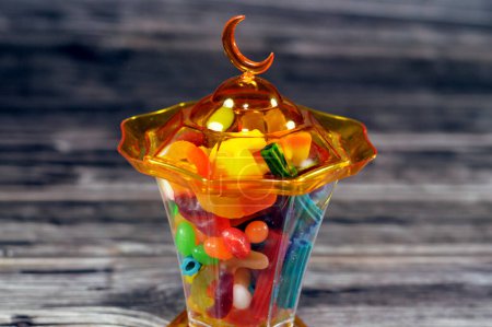 Ramadan lantern fanous lamp with assorted gummy candy, Gummies, gummi candies, gummy candies, or jelly sweets,  gelatin-based chewable sweets. Gummy sour jelly sweets candies in various shapes
