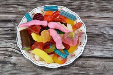 Gummy candy, Gummies, gummi candies, gummy candies, or jelly sweets,  gelatin-based chewable sweets. Gummy sour jelly sweets candies in various shapes, a popular confectionery for children
