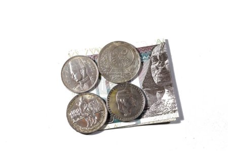 Egypt banknote with Egyptian silver coins of Orabi revolution, President Gamal Abdel Nasser, king Farouk I and the golden Jubilee of the Arab league, old vintage retro silver coins on 100 LE EGP pound